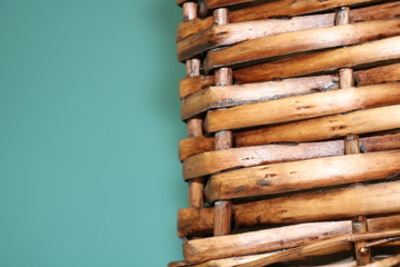 Brown wicker basket element on turquoise background.