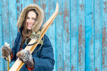 Beautiful woman with retro ski over vintage wooden wall happy smiling © PEPPERSMINT