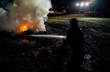 Firemen suppressing fire