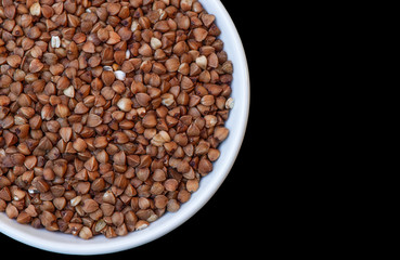 buckwheat grain cup black background