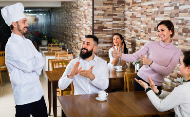  Happy chef listens to praise of the food