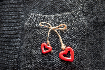 Fototapeta na wymiar On a knitted pocket hearts on a tourniquet