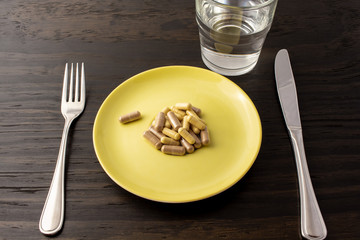Suppliments overload or fasting with suppliments. Representation of taking too much suppliment that one can be full from just supplimentation.