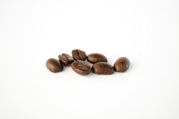 Coffee beans isolated on the white background. Grains of coffee close-up. Selective focus
