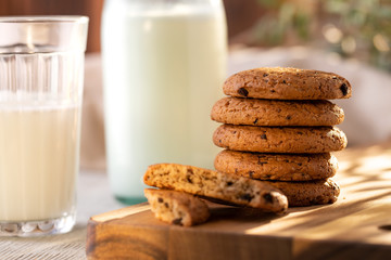 Oatmeal Cookies On A Wooden Board On A Sunny Day With A Glass And A Bottle Of Milk. Close-Up.