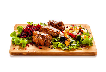 Wrapped pork with vegetables on white background