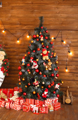 Christmas mood. Celebrating of New Year. Classic christmas spruce. Christmas presents/gifts under fir-tree. Vintage New Year decorations. Red gift boxes and lantern under fir-tree