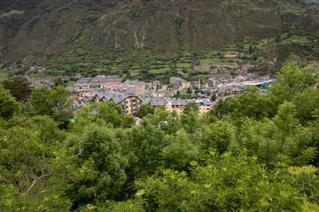 Fototapeta na wymiar Aerial view of a small village of Encamp, located in Pyrenees Mountains,in Andorra. Great place for hiking, trekking, camping. Great hike in the forest with lots of incredible views of the mountains