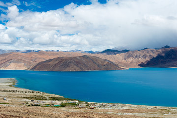 Obraz premium Ladakh, India - Aug 08 2019 - Pangong Lake view from Spangmik Village in Ladakh, Jammu and Kashmir, India. The Lake is an endorheic lake in the Himalayas situated at a height of about 4350m.