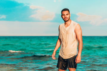 Fototapeta na wymiar Young man looking into distance on a beautiful beach