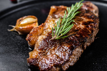 Beef strip loin steak on black background. Space for text. Marble premium beef. Close up.