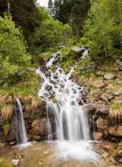 Obraz premium A small cascade waterfall, near a village of Encamp, Andorra. Located in the Pyrenees mountain