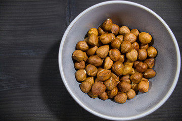 plate with nuts on a gray background with scattered hearts