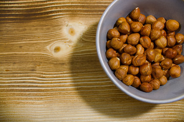 plate with nuts on a gray background with scattered hearts