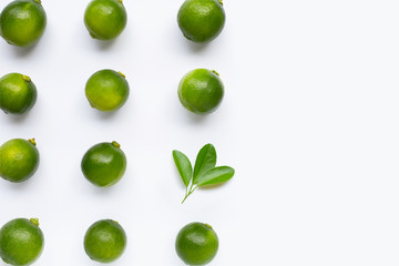 Fresh limes with leaves isolated on white