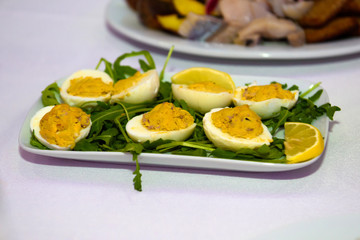 Eggs stuffed on the table. Snacks and utensils for a dinner party.