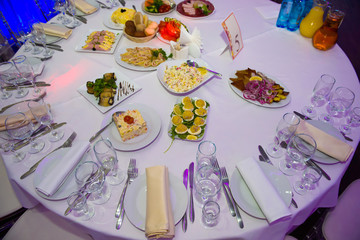 Festive table set with food. Snacks and utensils for a dinner party.