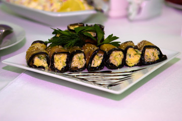 Eggplant stuffed on the table. Snacks and utensils for a dinner party.