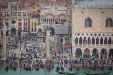 Tilt shift effect of tourists near Doge's Palace during high water, Venice, Italy