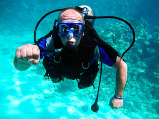 Man scuba diver and beautiful colorful coral reef underwater