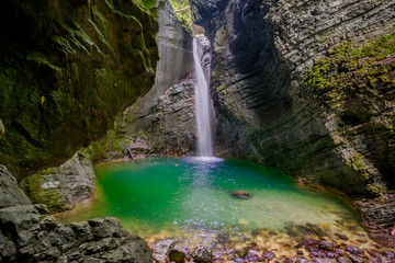 Fototapeta na wymiar Hidden waterfall in the mountain canyon