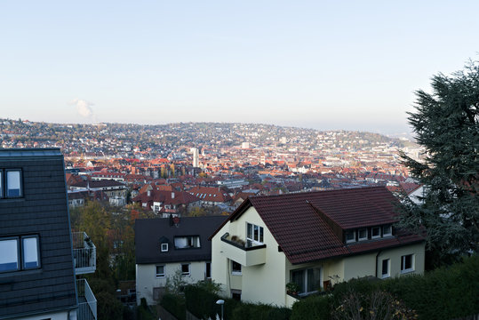 Germany, Skyline of city stuttgart in valley surrounded by hills covered by trees