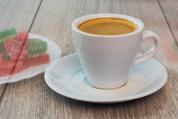 A cup of coffee and refusal of sweets. The image of marmalade is not contrasting.