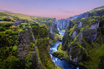 Amazing nature of Iceland. Impressive view on picturesque canyon Fjadrargljufur with colorful sky and reflections. Tipical Icelandic scenery during sunset. Iconic location for landscape photographers.