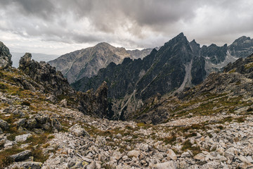 Fototapeta na wymiar Alpine like mountain landscape of High Tatras, Slovakia. Kezmarsky stit, Lomnicky stit and other High Tatra peaks in autumn. Rocky mountains of High Tatras.
