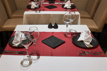 A table in a restaurant for two people waiting for visitors