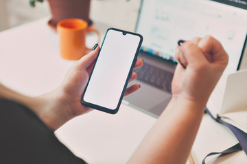girl holds phone in hand