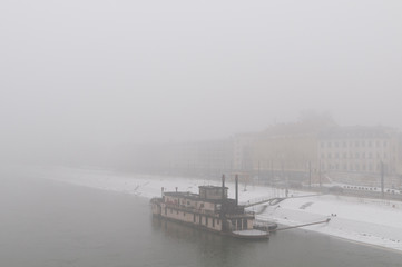 View from the bridge through the fog to the boat in Győr, Hungary
