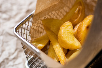 French fries close upon wooden table