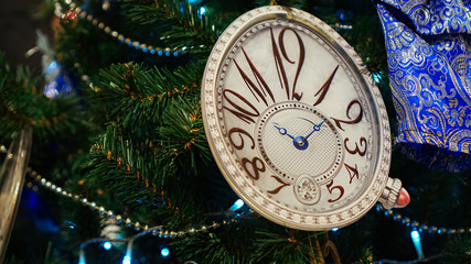 Christmas decorations on the tree. Clock.