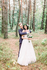 Fototapeta premium Gorgeous wedding rustic couple hugging and walking in autumn forest