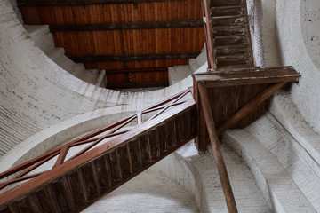 Old decrepit wooden staircase leading up inside of the building