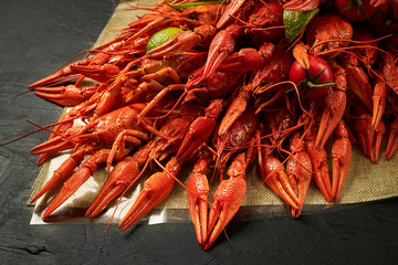 Fresh red boiled crawfish lie on a black background