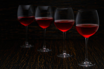 Red wine on a black wooden background, selective focus.