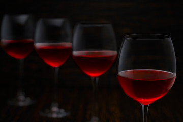 Red wine on a black wooden background, close up.