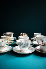 Vintage porcelain tea cups on blue background