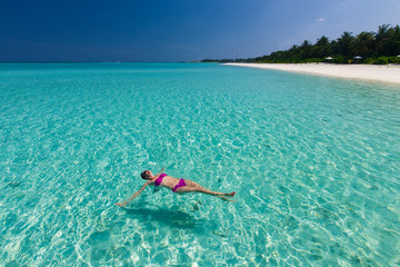 Young gorgeous woman in bikini on a tropical island