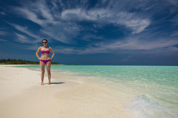 Fototapeta na wymiar Young gorgeous woman in bikini on a tropical island