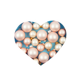 Paper cut out heart shape with christmas decoration inside. Xmas minimal background