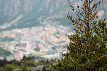 A view of Andorra La Vella from a hike high in the mountains around pine trees.