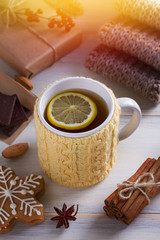 Cup of hot drink. Mug in knitted mitten. Autumn or winter cold weather concept