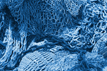 Abstract background with fishing net texture toned in blue monochrome