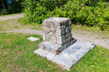 A stone drinking fountain in Ten Mile Lake Provincial Park, British Columbia, Canada