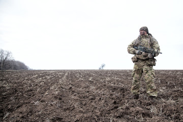 Army special forces machine gunner in field