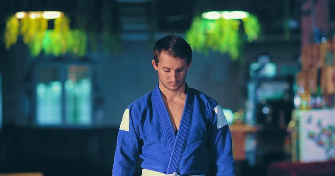 Young man is a fighter before the fight, tunes in to the competition with the enemy. Zoom in camera. Portrait view.
