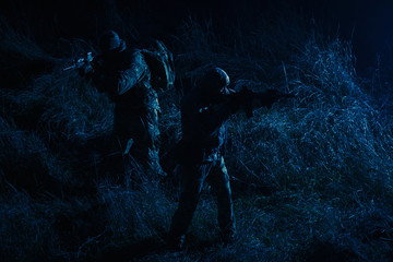 Army tactical group fighters sneaking in darkness